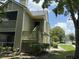 Two-story condo featuring inviting lattice stairwell and porch, with lush greenery enhancing the outdoor appeal at 3713 S Lake Orlando Pkwy # 6, Orlando, FL 32808