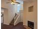 Cozy living area with a fireplace, complemented by a ceiling fan and staircase for comfortable living at 3713 S Lake Orlando Pkwy # 6, Orlando, FL 32808