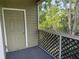 Relaxing outdoor patio with view to the greenery and door to the home's interior at 3713 S Lake Orlando Pkwy # 6, Orlando, FL 32808