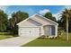 Charming single-Gathering home with a two-car garage, and blue front door with lush landscaping at 4102 Giorgio Dr, Winter Haven, FL 33884