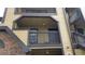 A tan apartment building with dark brown trim and railings, and a brick accent wall on the bottom left at 420 Forestway Cir # 202, Altamonte Springs, FL 32701