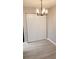 A dining area with white wood floors, a closet and a modern chandelier at 420 Forestway Cir # 202, Altamonte Springs, FL 32701