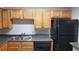 Kitchen featuring wood cabinets, dark countertops and black appliances at 420 Forestway Cir # 202, Altamonte Springs, FL 32701