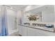 Well-lit bathroom with a double vanity, granite countertops, and a walk-in shower at 5174 Masser Rd, St Cloud, FL 34772