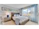 Cozy bedroom features nautical-themed decor and a large window for natural light at 5174 Masser Rd, St Cloud, FL 34772