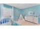 Bedroom featuring under the sea wall decorations, crib, and changing table at 5174 Masser Rd, St Cloud, FL 34772