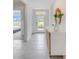 Bright entryway features neutral tile flooring, decor, and a white door with glass at 5174 Masser Rd, St Cloud, FL 34772