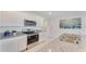 Bright kitchen featuring granite counters, stainless oven, and white cabinetry at 5174 Masser Rd, St Cloud, FL 34772