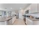 Bright kitchen boasts stainless appliances, granite counters, white cabinets, and an island with sink at 5174 Masser Rd, St Cloud, FL 34772