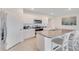 Bright kitchen with granite counters, island with sink, stainless oven, and white cabinetry at 5174 Masser Rd, St Cloud, FL 34772