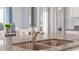 Close up of a kitchen island with granite countertops and stainless steel sink at 5174 Masser Rd, St Cloud, FL 34772