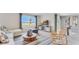 Open-concept living room with natural light, a cozy sofa, and modern furnishings at 5174 Masser Rd, St Cloud, FL 34772