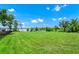 Large grass backyard with lake view in the background on a sunny day at 5552 Remsen Cay Ln, Windermere, FL 34786