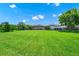 Expansive backyard with lush green lawn and mature trees, perfect for outdoor activities and relaxation at 5552 Remsen Cay Ln, Windermere, FL 34786