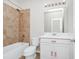 Bathroom with shower, tub, toilet and white vanity with pink bows at 5552 Remsen Cay Ln, Windermere, FL 34786