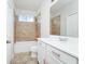 Bathroom with shower, tub, toilet and white vanity with pink bows at 5552 Remsen Cay Ln, Windermere, FL 34786
