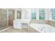 Bright bathroom featuring a soaking tub, shower, vanity, and natural light at 5552 Remsen Cay Ln, Windermere, FL 34786
