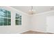 Bedroom with light wood-look flooring, chandelier, windows, and white trim at 5552 Remsen Cay Ln, Windermere, FL 34786