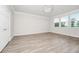 Bright bedroom with hardwood floors, a modern chandelier, white trim, and ample natural light at 5552 Remsen Cay Ln, Windermere, FL 34786