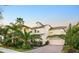 Elegant two-story home with brick driveway and tropical landscaping at 5552 Remsen Cay Ln, Windermere, FL 34786