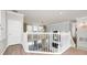 Bright hallway features elegant chandelier, wood floors, and white trim with access to other rooms in the home at 5552 Remsen Cay Ln, Windermere, FL 34786