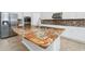 Close-up of a kitchen island featuring a unique granite countertop and stainless steel appliances at 5552 Remsen Cay Ln, Windermere, FL 34786
