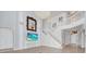 Bright, modern living room featuring a grand staircase, large TV, and elegant chandelier at 5552 Remsen Cay Ln, Windermere, FL 34786