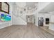 Expansive living area with open floor plan connecting to kitchen and grand staircase, chandelier included at 5552 Remsen Cay Ln, Windermere, FL 34786