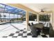 Screened patio with black and white tile, ceiling fan, table, and pool views at 5552 Remsen Cay Ln, Windermere, FL 34786
