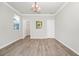 Well-lit room with hardwood floors, white trim and large window for natural light at 5552 Remsen Cay Ln, Windermere, FL 34786