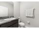 Small bathroom with granite counter, white toilet and towel rack with fresh white towel at 5846 Sw 80Th Ln, Ocala, FL 34476
