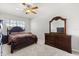 Bedroom with elegant wood furniture, plush carpet, and a ceiling fan at 5846 Sw 80Th Ln, Ocala, FL 34476