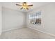 A comfortably sized bedroom featuring a ceiling fan, neutral paint, and plush carpeting at 5846 Sw 80Th Ln, Ocala, FL 34476