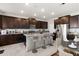 Modern kitchen featuring dark wood cabinetry, stainless steel appliances, and an island with bar seating at 5846 Sw 80Th Ln, Ocala, FL 34476