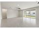 Spacious living room with sliding glass doors providing lots of natural light and tile flooring at 5846 Sw 80Th Ln, Ocala, FL 34476