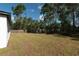 A large grassy backyard features a wood fence around the perimeter of the property at 6291 Sw 133Rd Street Road, Ocala, FL 34473
