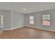 Bedroom featuring wood flooring and natural light from two windows at 6291 Sw 133Rd Street Road, Ocala, FL 34473