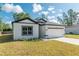 View of a bright, two-story home with well-kept lawn and attached two car garage at 6291 Sw 133Rd Street Road, Ocala, FL 34473