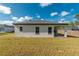 Exterior view of the house shows a well-kept lawn, covered patio, and roofline at 6291 Sw 133Rd Street Road, Ocala, FL 34473