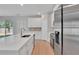 Bright, open-concept kitchen with hardwood floors, stainless steel appliances, and an island with a sink for modern living at 6291 Sw 133Rd Street Road, Ocala, FL 34473