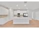 Modern kitchen with stainless steel appliances, white cabinets, an island, and a stylish backsplash for a clean, updated look at 6291 Sw 133Rd Street Road, Ocala, FL 34473