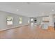 Bright, open-concept living area with hardwood floors, large windows, and seamless flow to the kitchen and outdoor space at 6291 Sw 133Rd Street Road, Ocala, FL 34473
