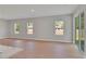 Spacious living room with wood flooring, natural light, and sliding glass doors to the patio at 6291 Sw 133Rd Street Road, Ocala, FL 34473
