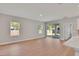 Open floorplan living room features wood floors, natural light and sliding glass doors to the back patio at 6291 Sw 133Rd Street Road, Ocala, FL 34473