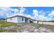 Back view of a single-Gathering home with a small, grassy yard and a privacy fence at 6300 Chirpine Ln, St Cloud, FL 34771