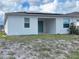 Back view of a single-Gathering home with solar panels and a sliding glass door at 6300 Chirpine Ln, St Cloud, FL 34771