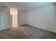 A carpeted bedroom with neutral walls, features a closet and an ensuite bath at 6300 Chirpine Ln, St Cloud, FL 34771