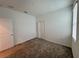 Bright bedroom featuring neutral carpet, closet and window with blind at 6300 Chirpine Ln, St Cloud, FL 34771