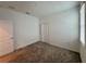 Bright bedroom featuring neutral carpet, closet and window with blind at 6300 Chirpine Ln, St Cloud, FL 34771