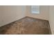 Carpeted bedroom features a window, providing natural light at 6300 Chirpine Ln, St Cloud, FL 34771